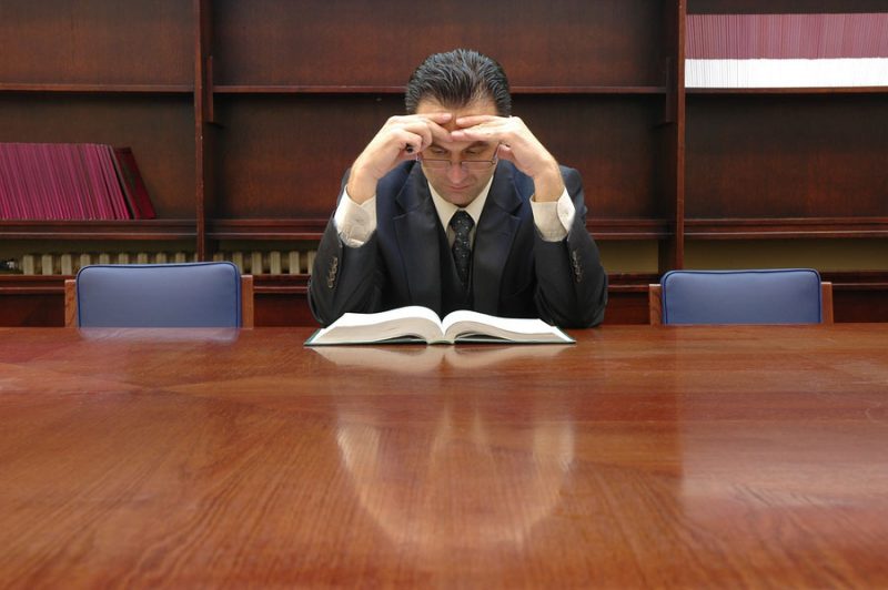 Lawyer mulling over a book