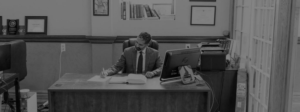 Photo of Purav Bhatt, Founder partner of The Law Office of Purav Bhatt, working at his desk.
