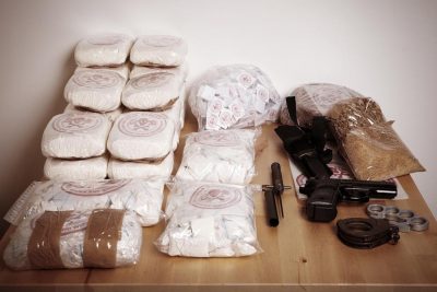 Chicago drug and weapons charge - Drug packages, raw opium, drug dozens and weapons seized by police