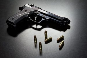 weapons charges Gun on a Table with Bullets | The Law Office of Purav Bhatt