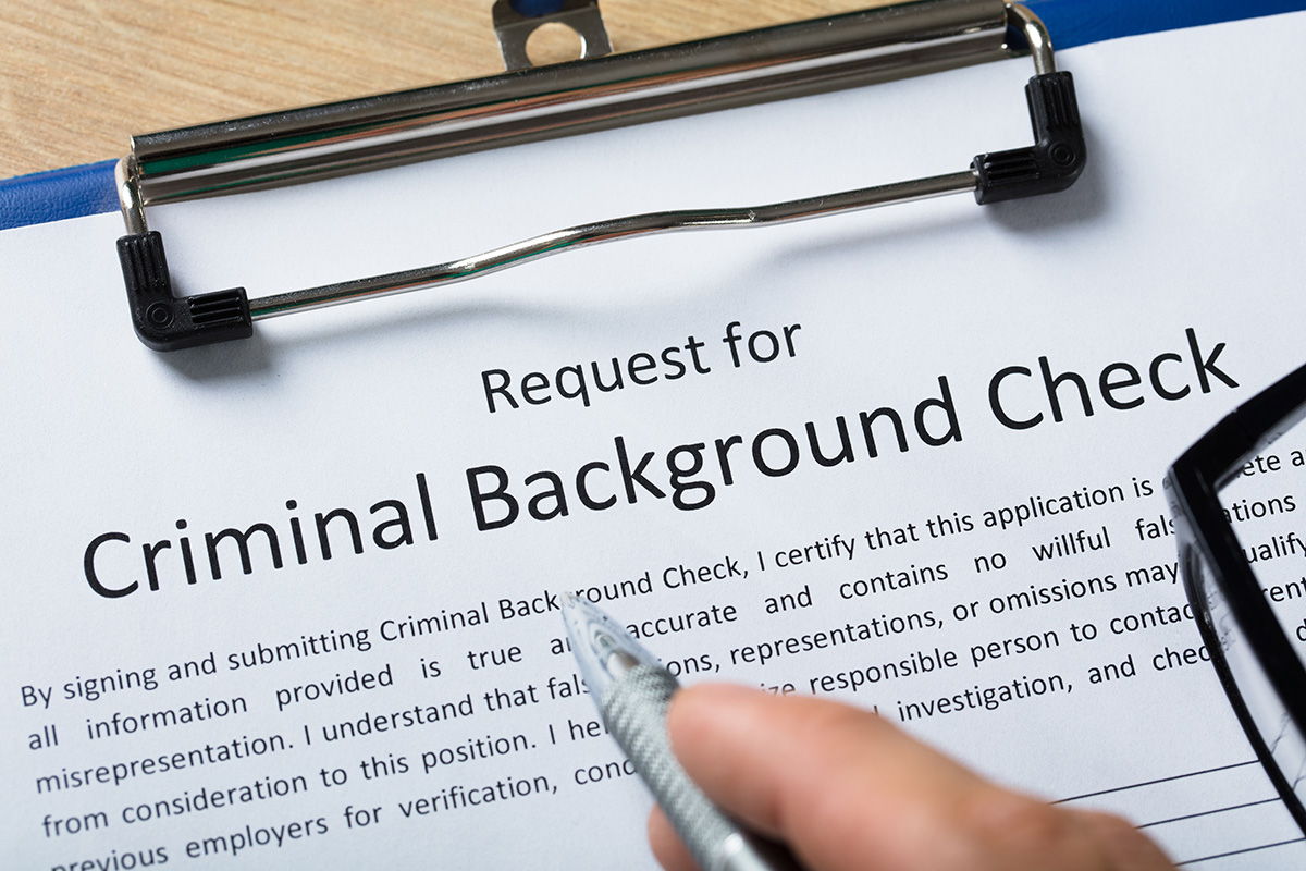 A clipboard with a form that says 'Background Check'