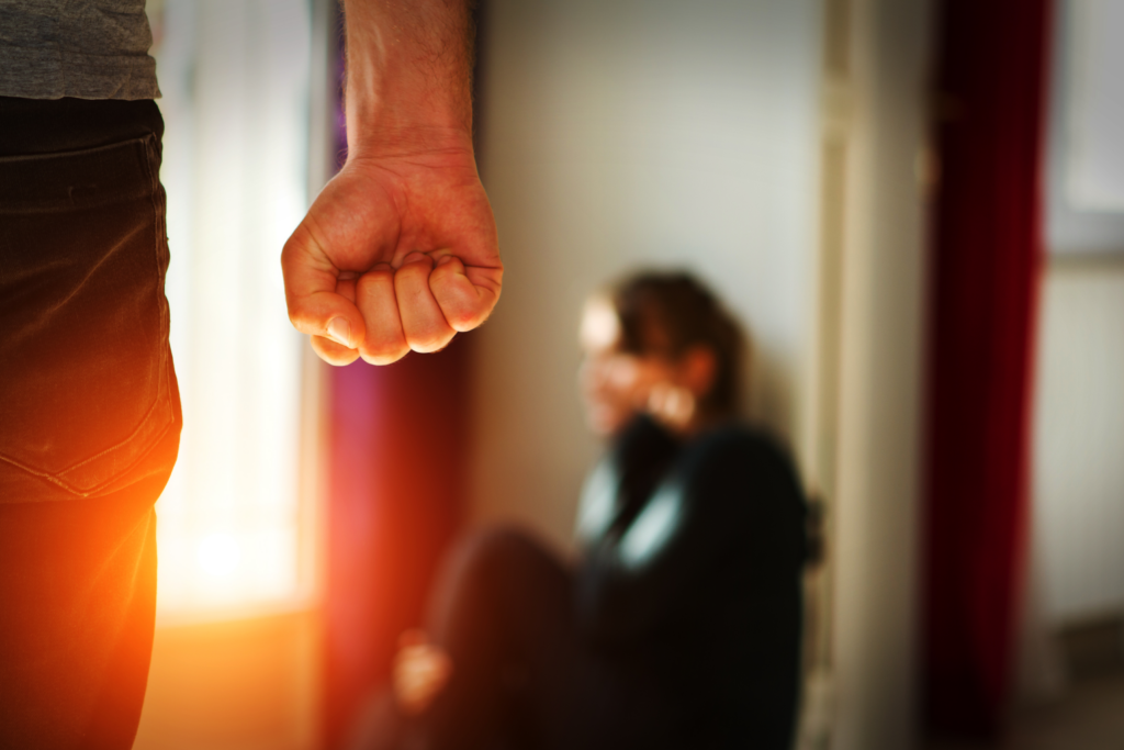 Man with fist clenched infront of abused woman - Chicago Criminal Defense Attorney