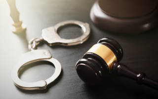 chicago dui defense - handcuffs on a table as a reference | The Law Office of Purav Bhatt